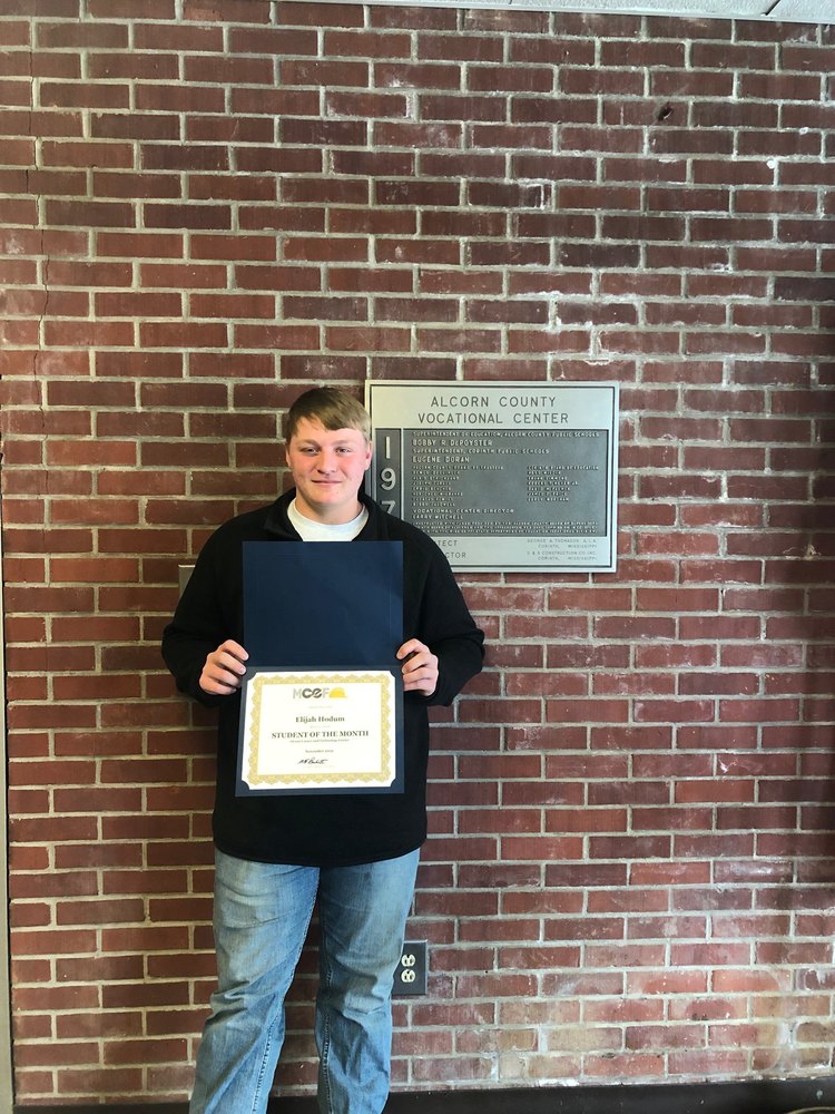 Elijah Hodum poses for a picture with his MCEF Student of the Month Certificate