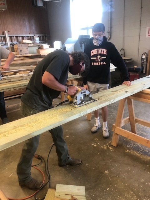 Jes Patrick (circular saw) with Russ Clifton holding
